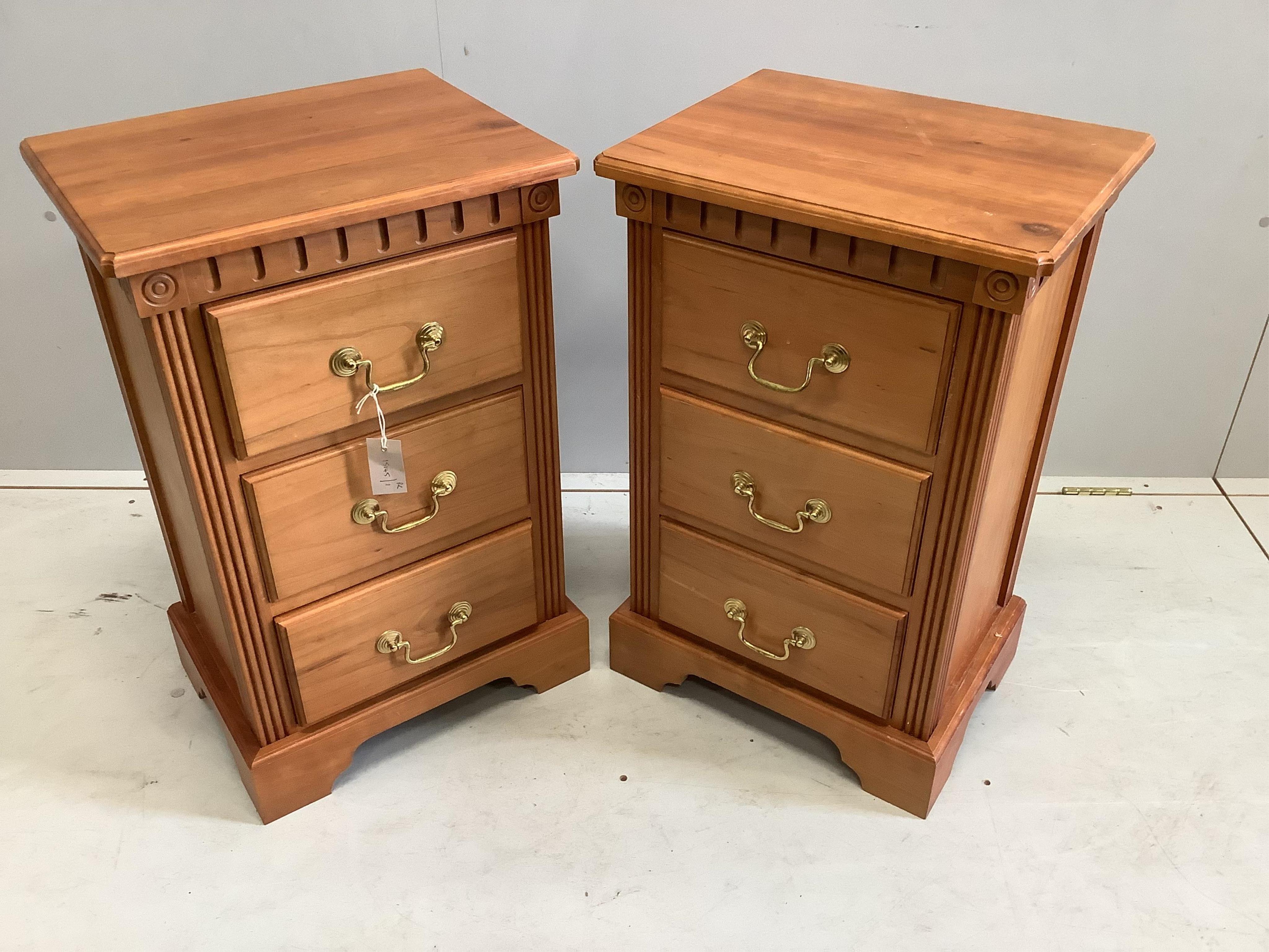 A pair of reproduction cherry three drawer bedside chests, width 45cm, depth 36cm, height 71cm. Condition - fair